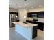 Modern kitchen with stainless steel appliances, quartz countertops, and a center island at 1053 Waterfall Blvd, Davenport, FL 33837