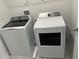 Well-lit laundry room features new, modern washer and dryer units, making laundry tasks efficient and convenient at 1053 Waterfall Blvd, Davenport, FL 33837