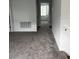 Spacious living room offers neutral paint, carpeting, and ample space for furnishings and decor to suit any style at 1053 Waterfall Blvd, Davenport, FL 33837