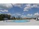 Resort-style swimming pool with a splash pad, lounge chairs, and a spacious deck, creating an inviting outdoor oasis for relaxation at 1053 Waterfall Blvd, Davenport, FL 33837