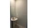Powder room with a pedestal sink, mirror, and neutral paint, offering a functional space at 1053 Waterfall Blvd, Davenport, FL 33837