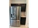 Stainless steel LG refrigerator with black cabinets, and sleek design at 1053 Waterfall Blvd, Davenport, FL 33837