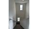 Bright staircase enhanced by natural light streaming through the windows provides a welcoming and airy entrance at 1053 Waterfall Blvd, Davenport, FL 33837