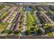 Wide aerial view showcasing the neighborhood's layout with a central pond, green space, and community amenities at 10733 Savannah Landing Cir, Orlando, FL 32832