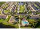 Aerial view of a community with pool, tennis court, green space, and a pond with walking trails at 10733 Savannah Landing Cir, Orlando, FL 32832
