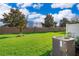 The backyard offers a vast, well-maintained lawn with a privacy fence, and some leafy trees at 10733 Savannah Landing Cir, Orlando, FL 32832