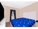 A minimalist bedroom features a bed with a butterfly-patterned duvet cover and neutral walls at 10733 Savannah Landing Cir, Orlando, FL 32832