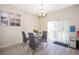 Dining room with a glass table set and sliding glass doors to the outside at 10733 Savannah Landing Cir, Orlando, FL 32832