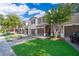 Charming townhouses with a brick driveway, lush green lawn, and well-maintained landscaping at 10733 Savannah Landing Cir, Orlando, FL 32832
