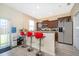 Kitchen featuring granite countertops, stainless steel appliances, breakfast bar, and neutral finishes at 10733 Savannah Landing Cir, Orlando, FL 32832