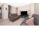 Inviting living room with modern sofas, a large television, and neutral walls and flooring at 10733 Savannah Landing Cir, Orlando, FL 32832