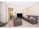Inviting living room with modern sofas, a large television, and neutral walls and flooring at 10733 Savannah Landing Cir, Orlando, FL 32832
