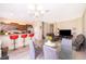 The living room and dining areas blend, showing red breakfast bar stools and a comfy gray sofa at 10733 Savannah Landing Cir, Orlando, FL 32832