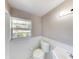 Clean bathroom with white fixtures, wainscoting, and a bright window for natural light at 114 N Alderwood St, Winter Springs, FL 32708