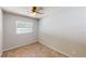 Cozy carpeted bedroom featuring a ceiling fan, light gray walls, and natural light from a window at 114 N Alderwood St, Winter Springs, FL 32708