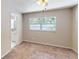 Bedroom featuring plush carpet, a ceiling fan, and a window overlooking the backyard at 114 N Alderwood St, Winter Springs, FL 32708