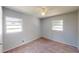 Carpeted bedroom with ample natural light from two windows and neutral paint at 114 N Alderwood St, Winter Springs, FL 32708