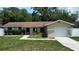 Charming single-Gathering home with an attached one-car garage, arched entryway, and neatly kept landscaping at 114 N Alderwood St, Winter Springs, FL 32708