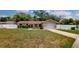 Charming single-story home with a well-manicured lawn, white picket fence, and a one-car garage at 114 N Alderwood St, Winter Springs, FL 32708