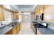 Well-lit kitchen featuring stainless steel appliances, tile flooring, and neutral countertops and cabinetry at 114 N Alderwood St, Winter Springs, FL 32708