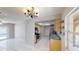 Bright kitchen adjacent to a dining area, featuring tile flooring and stainless steel appliances at 114 N Alderwood St, Winter Springs, FL 32708