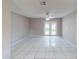 A bright, spacious living area featuring tile flooring and double glass doors to the yard at 114 N Alderwood St, Winter Springs, FL 32708