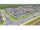 Aerial view of community, showcasing blue townhomes, mature trees, and other real estate in the neighborhood at 12190 Plumpton Dr, Winter Garden, FL 34787