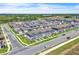 Aerial view of community, showcasing blue townhomes, mature trees, and other real estate in the neighborhood at 12190 Plumpton Dr, Winter Garden, FL 34787