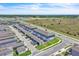 Aerial view of community, showcasing blue townhomes with garages and driveways, and other real estate in the neighborhood at 12190 Plumpton Dr, Winter Garden, FL 34787