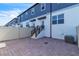 Rear patio area with paver surface, and stairway to the unit, enclosed with a white fence at 12190 Plumpton Dr, Winter Garden, FL 34787