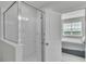 Bathroom features tiled shower and view to main bedroom at 12190 Plumpton Dr, Winter Garden, FL 34787