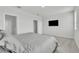 Bright main bedroom features a wall-mounted TV, neutral tones, and large windows at 12190 Plumpton Dr, Winter Garden, FL 34787