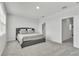 Spacious bedroom with plush carpeting and a comfortable gray upholstered bed at 12190 Plumpton Dr, Winter Garden, FL 34787