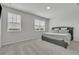Spacious bedroom with plush carpeting and a comfortable gray upholstered bed at 12190 Plumpton Dr, Winter Garden, FL 34787