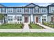 Charming townhome featuring a light blue exterior, well-manicured lawn, and inviting entryway at 12190 Plumpton Dr, Winter Garden, FL 34787
