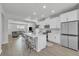 Open concept kitchen with white cabinets, island with seating, and stainless steel appliances at 12190 Plumpton Dr, Winter Garden, FL 34787