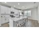 Modern kitchen with white cabinets, stainless steel appliances, and island with bar seating at 12190 Plumpton Dr, Winter Garden, FL 34787