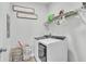 Functional laundry room with a modern washer and dryer and upper storage shelves at 12190 Plumpton Dr, Winter Garden, FL 34787