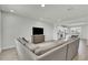 Cozy living room with a large sectional sofa, TV, and an open view into the kitchen at 12190 Plumpton Dr, Winter Garden, FL 34787
