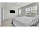 Bright main bedroom features a wall-mounted TV, neutral tones, and large windows at 12190 Plumpton Dr, Winter Garden, FL 34787