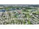 Drone view displays neighborhood close to a golf course and ponds, illustrating a peaceful residential setting at 124 Ashton Dr, Davenport, FL 33837