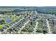Expansive overhead shot of community near a golf course, lake, and woodland, revealing location among vast surroundings at 124 Ashton Dr, Davenport, FL 33837