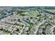 Overhead view features the house situated within a golf course community with lakes, offering a scenic and active lifestyle at 124 Ashton Dr, Davenport, FL 33837