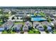 Aerial view showcases homes near a tennis court, pool, and clubhouse, highlighting community amenities and landscaping at 124 Ashton Dr, Davenport, FL 33837