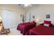 Cozy bedroom with two beds, soft lighting, and a view into the hallway at 124 Ashton Dr, Davenport, FL 33837