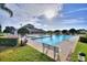 Large community pool featuring clear water, lush landscaping and a community center at 124 Ashton Dr, Davenport, FL 33837
