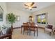 Bright dining room features a ceiling fan, large window, and a dining table with chairs at 124 Ashton Dr, Davenport, FL 33837