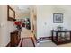 Carpeted entryway features hall table, mirror, and leads into living room with sliding glass doors at 124 Ashton Dr, Davenport, FL 33837