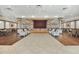 Large event space with a stage area, neutral color scheme, and plenty of seating for social activities at 124 Ashton Dr, Davenport, FL 33837