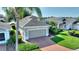 Well maintained single story home featuring a brick driveway and mature landscaping at 124 Ashton Dr, Davenport, FL 33837